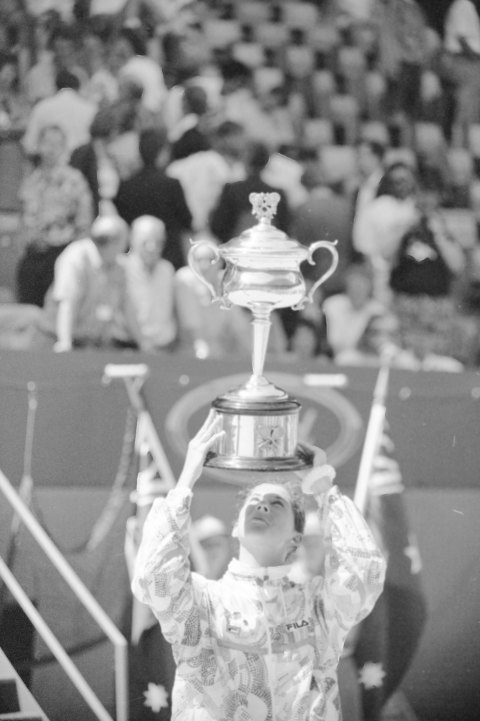 Monica Seles lifts the 1993 Australian Open Trophy.