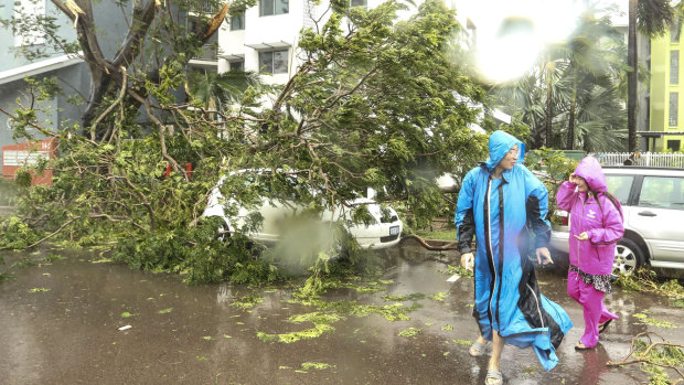 A pair examine the destruction after Cyclone Marcus passed over Darwin on Saturday.