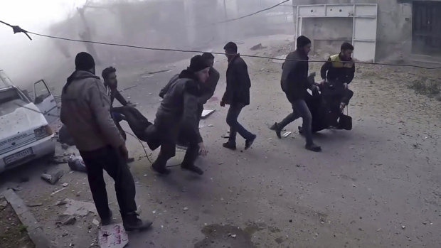 Members of the Syrian Civil Defense group and civilians carrying victims after airstrikes hit in Ghouta, a suburb of Damascus, Syria, on March 1.