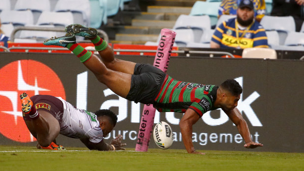 Inside the chalk: Robert Jennings leaps for a try at a drenched ANZ Stadium.