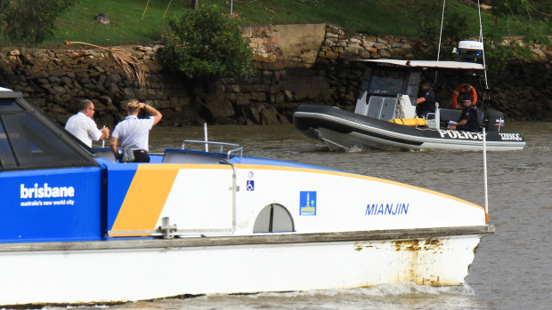 Police search the Brisbane River on Wednesday.
