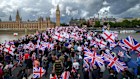 Protesters wave Union Jack and St George’s England flags during the “Unite The Kingdom” rally in London. 