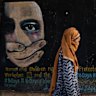 A woman walks past a mural calling for women and children’s rights in Bamian, Afghanistan.
