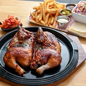 Original wood-fired chicken is paired with chips or tteokbokki (rice cakes).