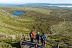 Hikers on Cuilcagh Boardwalk, in Ireland’s Hidden Heartlands, a destination for those who prefer unhurried journeys.