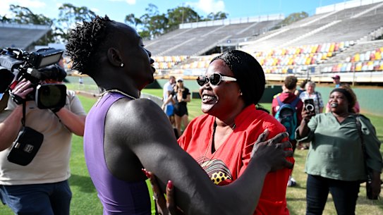 Gout Gout is embraced by his mother Monica Gout after his win in the 200m.