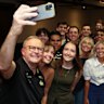 Anthony Albanese takes a selfie with Queensland University students and staff. Government policy has robbed young people of hundreds of thousands of dollars over the course of their working lives.