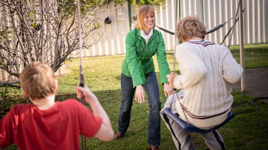 Briana Blackett plays with her two sons, who have autism, in their backyard.