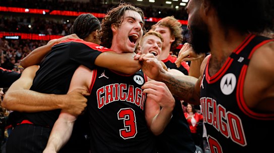Josh Giddey #3 of the Chicago Bulls celebrates with teammates after hitting a game-winning three pointer against the LA Lakers.