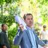 Auctioneer Simon Graf, of Simon Graf Real Estate, taking bids on 9/28 Tivoli Place, South Yarra.