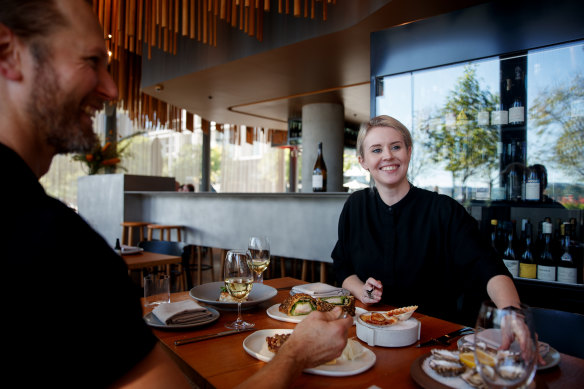 Polly Mackarel and Aiden Stevens with a selection of seafood dishes at Cirrus Dining in Barangaroo.