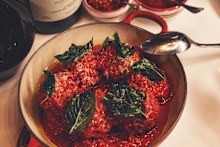 Mario’s meatballs from Carbone, topped with freshly grated Parmigiano-Reggiano, olive oil and a fried basil leaf.