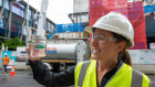 Abigail Heywood, Lendlease national sustainability manager – strategic projects, holds a container of renewable diesel.
