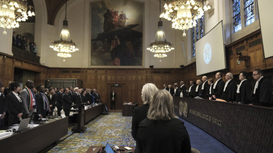Judges and parties stand up during a hearing at the International Court of Justice in The Hague, Netherlands, Friday, Jan. 12, 2024. The United Nations’ top court opened hearings Thursday into South Africa’s allegation that Israel’s war with Hamas amounts to genocide against Palestinians, a claim that Israel strongly denies. (AP Photo/Patrick Post)