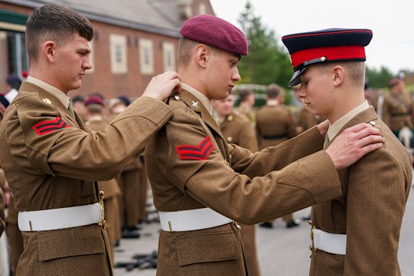 Junior soldiers at the Army Foundation College in Harrogate make final preparations before marching onto the Regimental square to take part in their graduation parade in Harrogate, England.