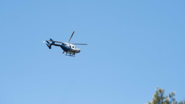 A police chopper watches the procession.