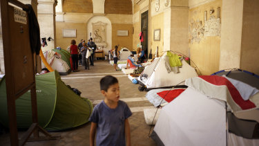 Homeless Italians and migrants camp under the portico of the Roman Catholic Basilica of the Twelve Holy Apostles in downtown Rome in 2017.