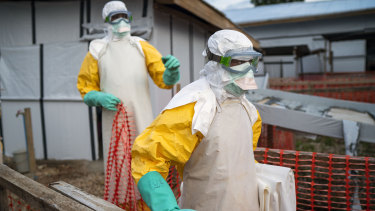 Health workers wearing protective suits take their shift at a treatment centre in Beni, Congo.