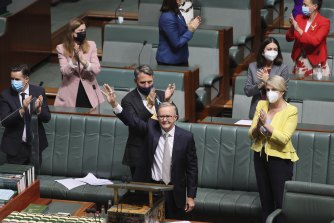 Opposition Leader Anthony Albanese waves to people in the public gallery after delivering the Budget reply speech.