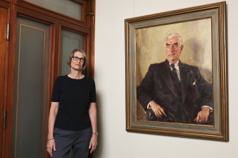 The Museum of Australian Democracy’s Kate Armstrong, next to Ivor Hele’s 1954 replacement portrait of Menzies.