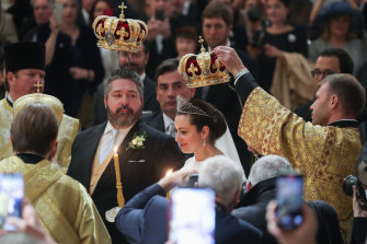 Relatives took turns in holding imperial crowns above the couple, Grand Duke George Mikhailovich Romanov and Rebecca Romanova Bettarini.