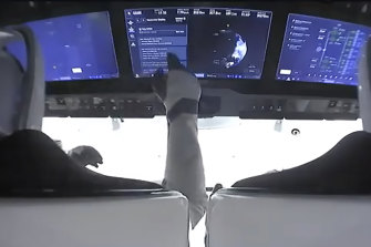 Astronauts in the cockpit of the SpaceX Crew Dragon spacecraft after liftoff.