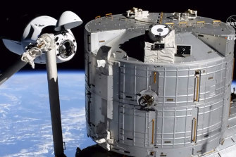 Elon Musk’s SpaceX Crew Dragon spacecraft, left, docking with the International Space Station in April 2021.