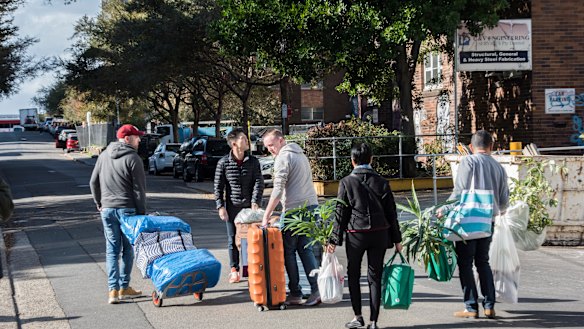 Residents packing up items including a piano from their units in the Mascot Towers Building.
