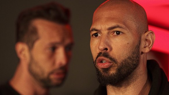 Andrew Tate (right) speaks to the media next to his brother Tristan in a file picture.