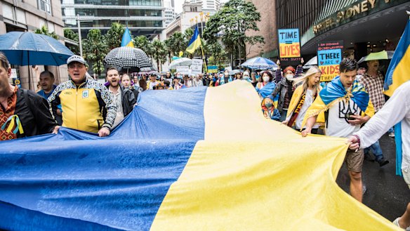 The Ukrainian flag is carried along Elizabeth Street in Sydney during a Stop War in Ukraine rally on Saturday.