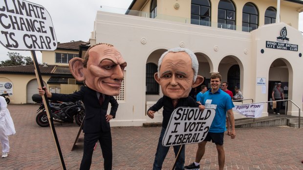 Members of GetUp dressed in costumes of Tony Abbott and Malcolm Turnbull at Bondi Surf Bathers Life Saving Club.