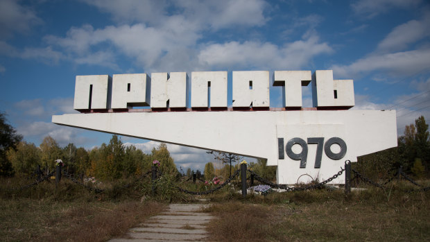 Flower offerings sit at the bottom of the Pripyat welcome sign. Founded in 1970 as a nuclear satellite city, the town is located only three kilometres away from the power plant.  