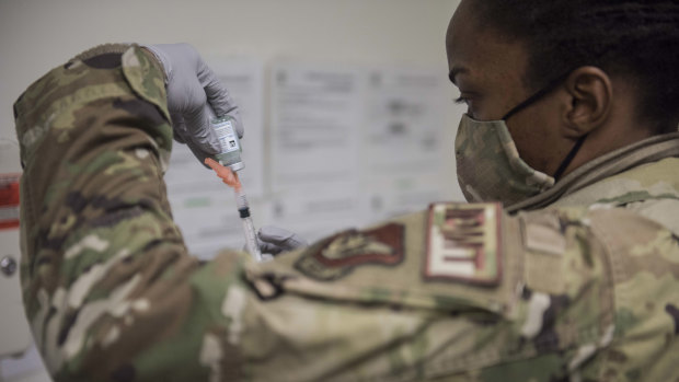 US Air Force Technical Sergeant. Alexisa Humphrey prepares to administer the Moderna COVID-19 vaccine at Kunsan Air Base in South Korea last year. 