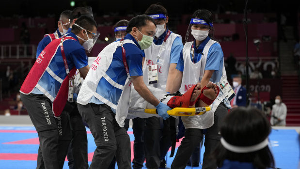 Jonathan Horne of Germany is taken away after being injured in the men’s kumite +75kg elimination round. 