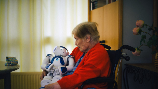 A patient sits with Zora at the Jouarre nursing facility outside Paris.