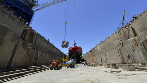 Contractors prepare to exchange the propellers on the Coast Guard Cutter Polar Star while it undergoes repair work at a dry dock in Vallejo, California. 