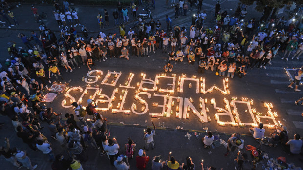 Demonstrators take part in a candlelight vigil for the victims of the past days of protests in Cali, Colombia.