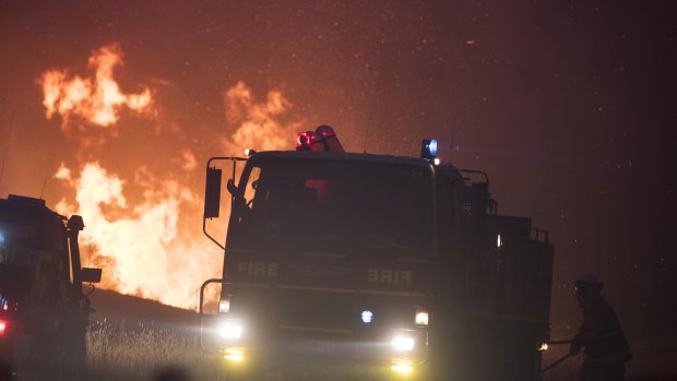 Firefighters work to contain the Pelham Road fire in southern Tasmania on Monday.