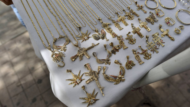 A man sells jewellery using narco-culture imagery in downtown Culiacan, in Mexico's Sinaloa state.