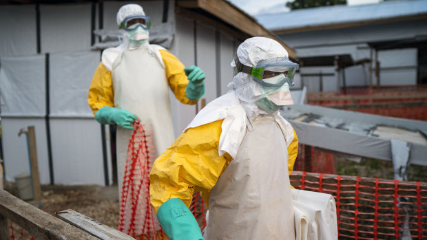 Health workers wearing protective suits take their shift at a treatment center in Beni, Congo DRC. 