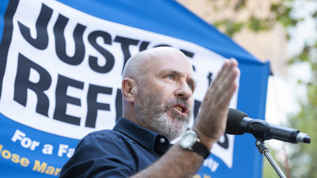 Author Richard Flanagan speaks during a Palm Sunday Rally for refugees outside the State Library in Melbourne.