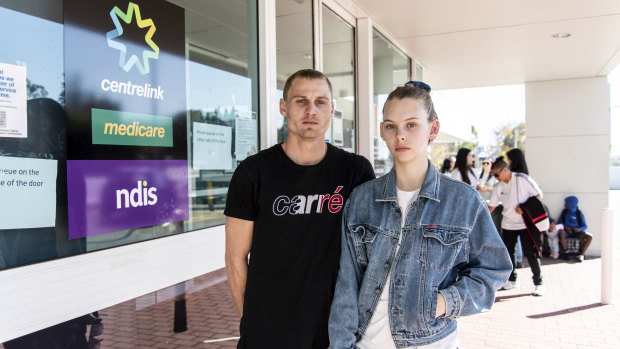 Benjamin Bowden, 26, and Erin Dawson, 20, line up outside of their local Centrelink office. 
