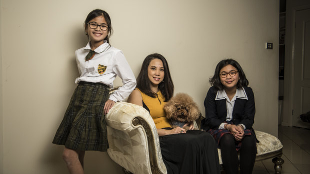 "The standard is higher": Yuliana Hartanto with her two daughters, Sienna, 12, and Felicia, 15. 