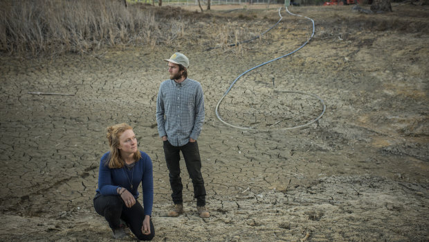 Erika Watson and Hayden Druce, owners of Epicurean Harvest, in a dried-out dam on their property in Hartley.