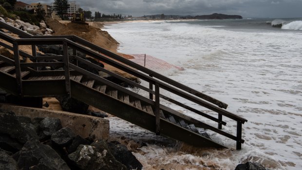 Beach sand erosion along Narrabeen beach on high tide as large southerly swells hit the coast. 