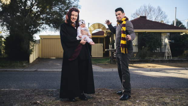 Andrew and Bec Grayson and baby girl Aurora at home in their Harry Potter cosplay outfits.