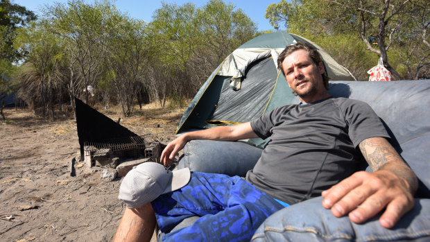 Tristan sits outside of his tent at the Rockingham shanty town, a makeshift camp home to 17 people. 