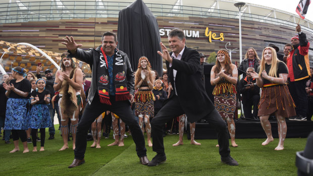 Nicky Winmar and Aboriginal campaigner and artist Richard Walley perform next to the Middar Dance Group.