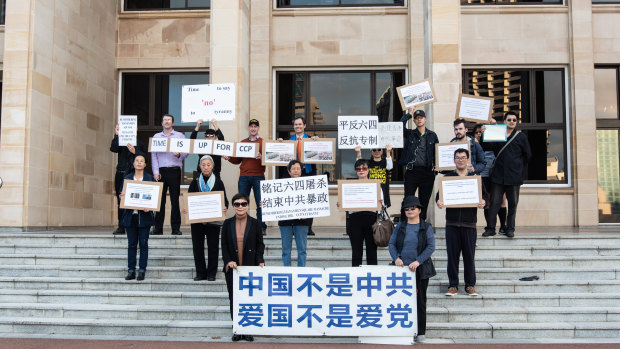 Protesters hold anti-CCP signs during the protests on June 4. 