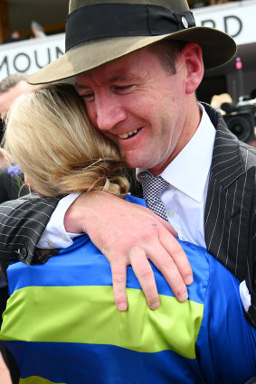 Ciaron Maher hugs Jamie Kah after winning a race for the late Colin McKenna on Victoria Derby Day.